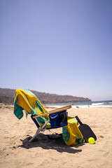 beach chair with pickleball paddle and ball