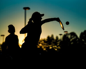 Pickleball players at sunset