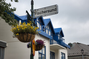 Reykjavík city street sign adorned with flower pots