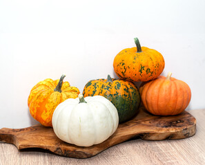 Orange Halloween pumpkins on wooden table, holiday decoration. Preparation for Halloween celebrating.