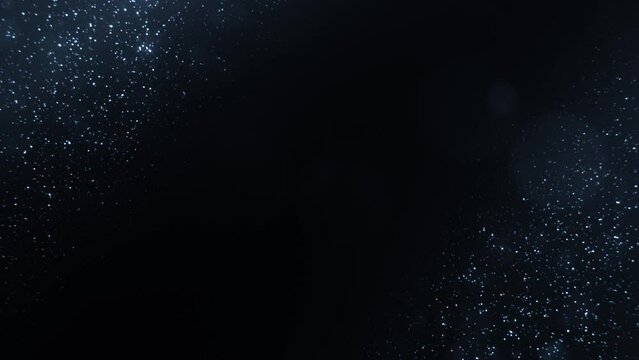Blue Particles on Black Background. Glitter Particles with Stars. Bokeh Shiny Particles Loop Animation.