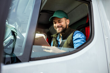 Young handsome man working in towing service and driving his truck.