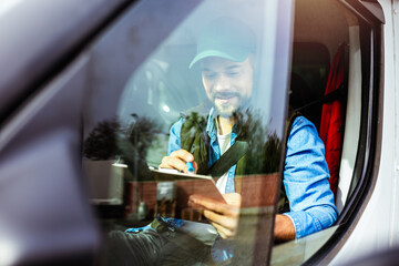 Young handsome man working in towing service and driving his truck.