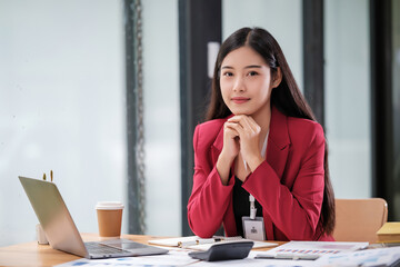 Asian Businesswoman Using Laptop In Modern Office.