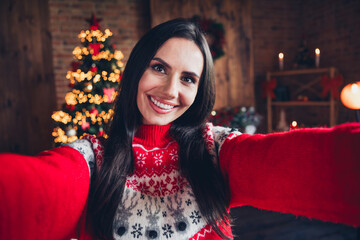 Photo of adorable cheerful girl wearing red ornament sweater shooting recording video blog vlog indoors