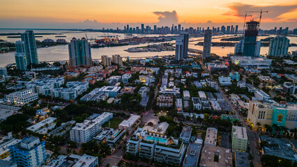 aerial establishing overview of Miami South Beach district at dusk, flashing building lights
