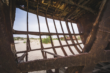 Rusty ships and boats in the desert at the bottom of the dried up Aral Sea in Uzbekistan, an ecosystem tragedy