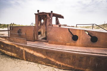 Rusty ships and boats in the desert at the bottom of the dried up Aral Sea in Uzbekistan, an ecosystem tragedy