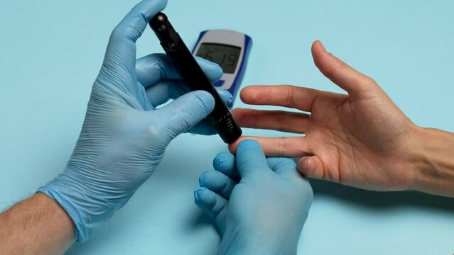 Doctor checking blood sugar level with glucometer.