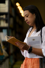 Mujer leyendo un libro en la biblioteca - obrazy, fototapety, plakaty