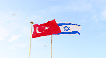 Turkey and Israel flags waving together on blue sky. 