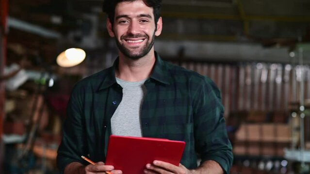 Portrait of guitar luthier small business owner in workroom, arts and craft concept