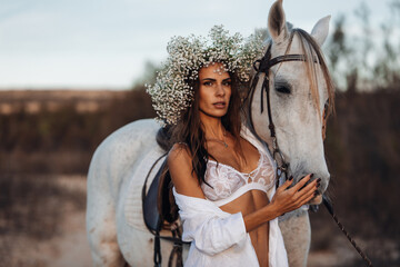 Portrait of a white horse and sexy lady. Beautiful glamour woman with a horse. Portrait of a beauty...