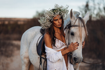 Portrait of a white horse and sexy woman. Beautiful glamour woman with a horse. Portrait of a...