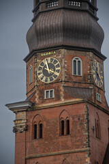 The close-up view of the church tower with the clock of the main church of St. Katharinen in Hamburg