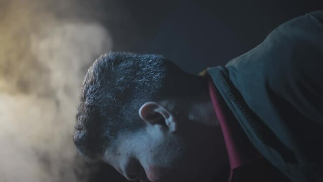 A film like shot of a Man spitting blood after a Hit by Punch - HD