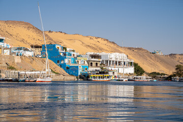 Colorful houses of Aswan, Nubian village, in Egypt during a sunny summer day - obrazy, fototapety, plakaty