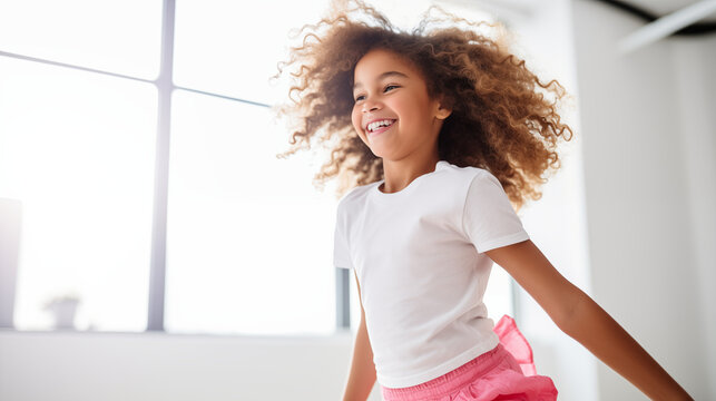 A African American girl engaged in a virtual dance class, her smile reflecting the joy of movement, white home background, blurred background, with copy space