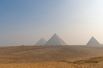 Giza Pyramids landscape during a sunny day, copy space, sand
