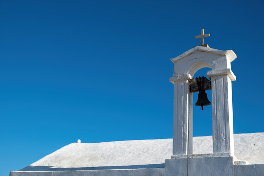 Church belfry, white chapel roof on blue sky background, Gavdos island, Crete, Greece. Copy space