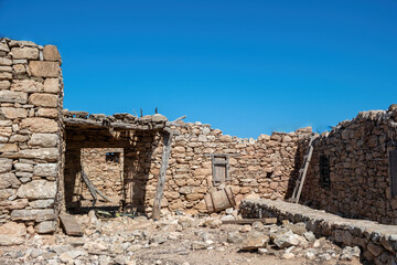 Abandoned stone built farmhouse at Gavdos island, Crete Greece. Ruins of former settlement, blue sky