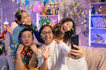 group of friend fun shooting selfie smartphone photo together on sofa couch friend fun playful christmas and new year party event positive conversation in living room at home with decorative interior