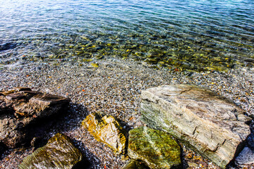 Sea stones on the beach in the sand. Sea landscape. HDR Image (High Dynamic Range).