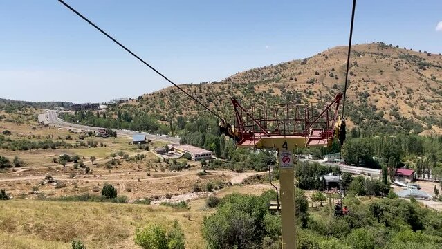 moving down on a chair lift in the summer in the mountains of Chimgan