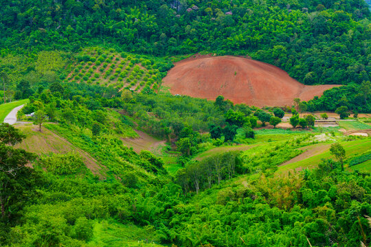 An aerial view of a hill that has been cleared for agriculture in Loei Province, Thailand.