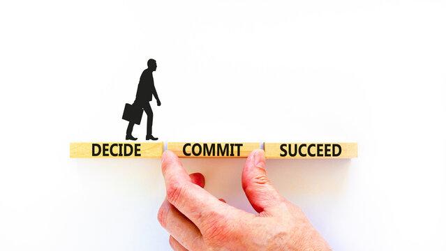 Decide commit succeed symbol. Concept word Decide Commit Succeed on beautiful wooden block. Businessman hand. Beautiful white table background. Business decide commit succeed concept. Copy space.