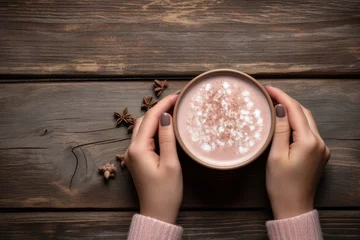 Foto op Plexiglas Top view of female hands holding a cup of hot cocoa on rustic wooden table with copy space. Generative Ai © bluebeat76