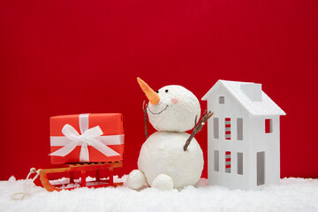 red christmas background with sleigh house and snowman