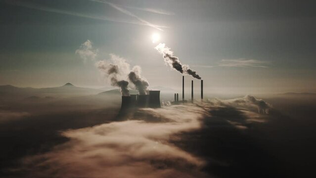 aerial view of coal fired power station and Combined cycle power plant at mist and sunset , Pocerady, Czech republic