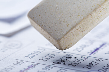 Fix with eraser financial data in document. Concept of banking, financial report and financial audit.