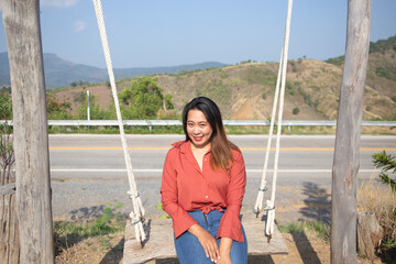 Smiling Woman On Swing