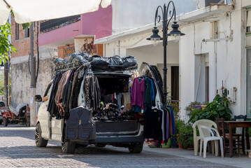 Mochos, Crete, Greece.  30.09.2023.  Mobile van with a collection of clothing sold door to door in the small town of Mochos, Crete.