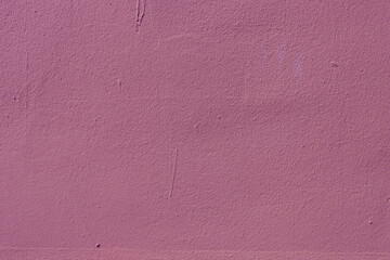 Surface texture of rough pink plaster.