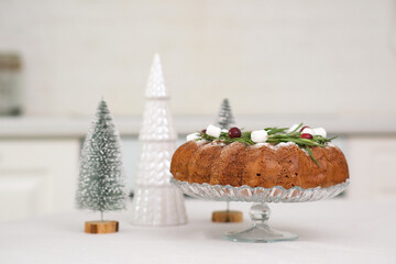 Christmas home interior in white kitchen Christmas chocolate bundt cake with fresh berries and rosemary. Winter baking. christmas trees. High quality photo