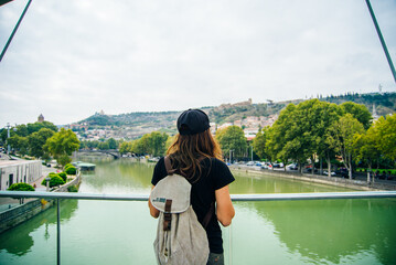 Tourist walking on bridge of peace in Tbilisi, Georgia
