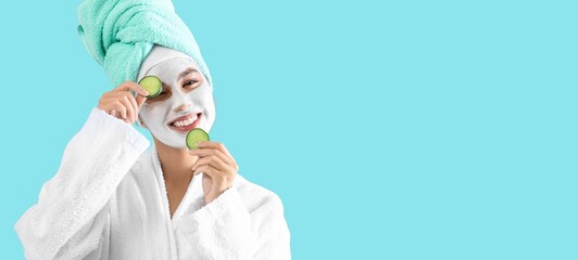 Beautiful young African-American woman with cucumber slices and facial mask on light blue background with space for text. Cosmetology concept