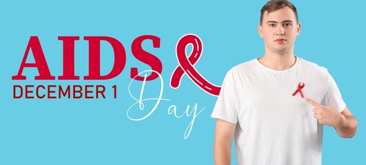 Young man with red ribbon on light blue background. Banner for World AIDS Day