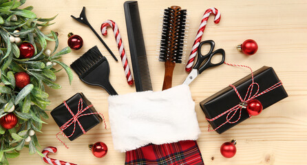 Hairdresser's supplies with Christmas sock and decor on wooden background