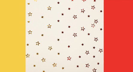 Abstract concept with red and yellow stars and red and yellow paper on a baige background. Party...
