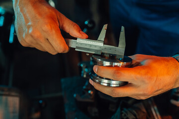 Caliper measuring a metal cylinder, roll cut in a metallurgy factory.
