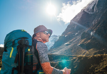 Portrait Young hiker backpacker man enjoying valley view in Makalu Barun Park route near Khare during high altitude acclimatization walk. Mera peak trekking route, Nepal. Active vacation concept image