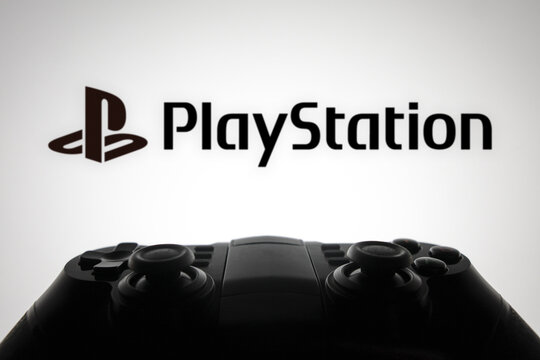 October 25, 2023, Brazil. In this photo illustration, the PlayStation logo is displayed on a computer screen, next to a gamepad.