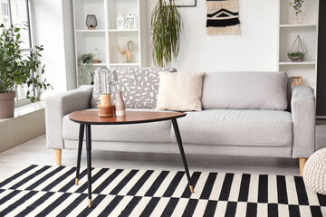 Interior of stylish living room with grey sofa and coffee table