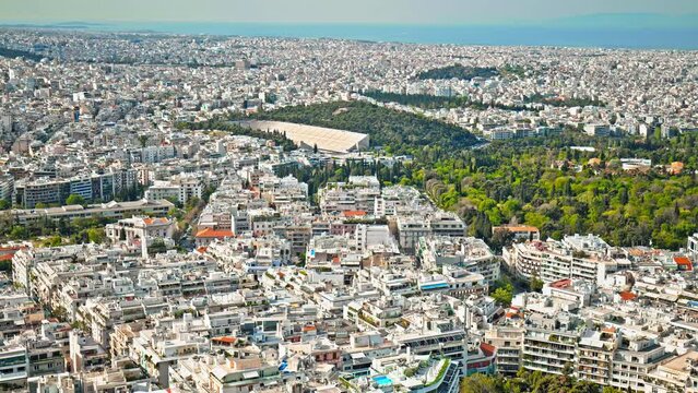 A tourist destination featuring the highest point of Mount Lycabettus. Panorama view of the Panathenaic Stadium, the Temple of Olympian Zeus, the Hellenic Parliament and the Acropolis of Athens.