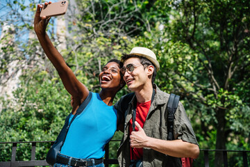 Multi-ethnic couple taking a selfie in an urban park