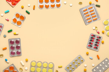 Frame made of different pills in blister packs on yellow background